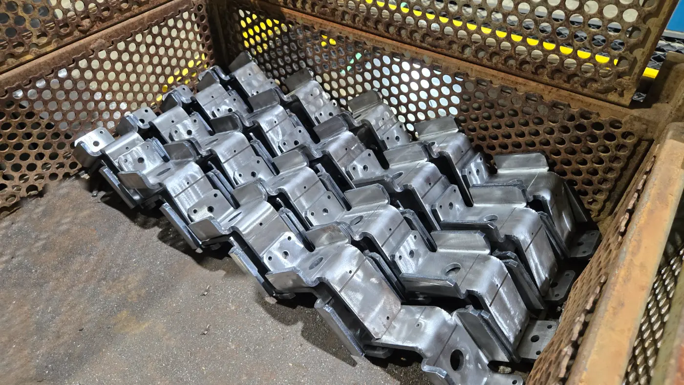 Wire bin full of bent steel brackets